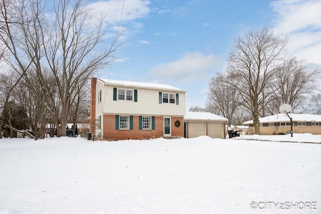 colonial home with an outdoor structure and brick siding