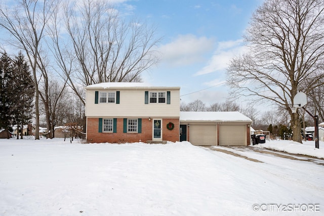 colonial house featuring brick siding and an attached garage