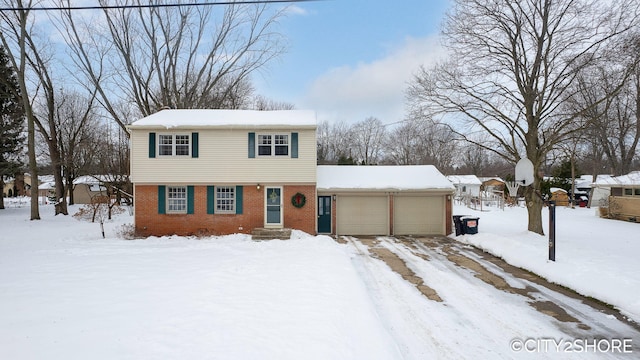 colonial home with a garage and brick siding