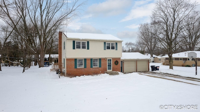 colonial home with brick siding and an attached garage