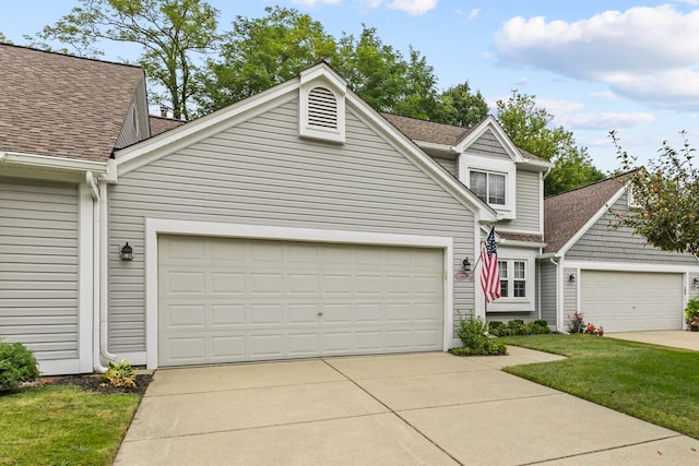 view of front of property with a garage and roof with shingles