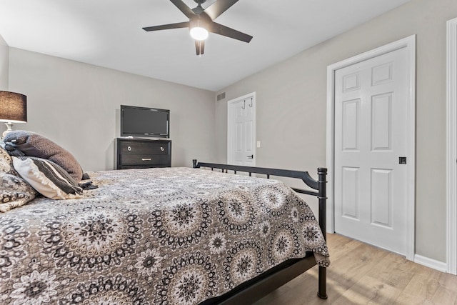 bedroom featuring visible vents, ceiling fan, and light wood-style flooring