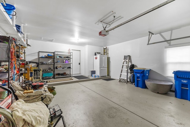 garage with a garage door opener and freestanding refrigerator