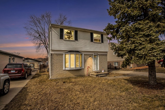 view of front facade with brick siding and driveway