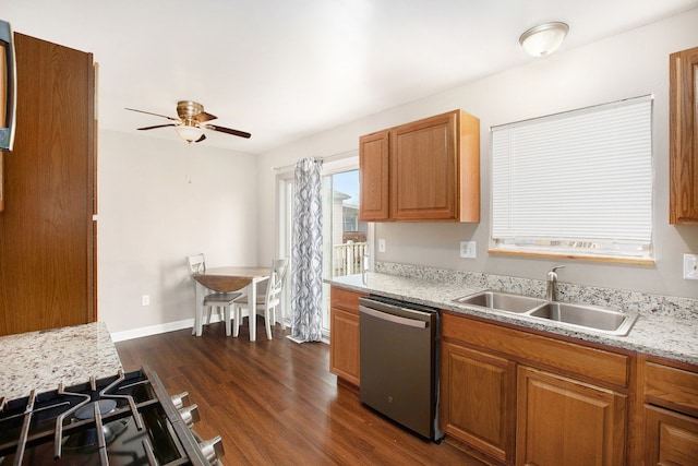 kitchen featuring dark wood-style floors, a ceiling fan, a sink, dishwasher, and brown cabinets