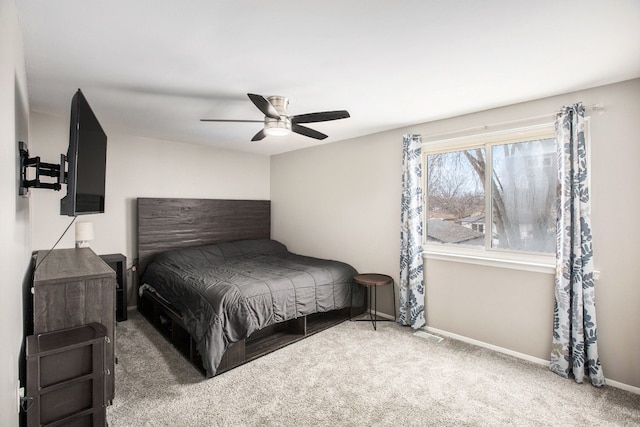 carpeted bedroom featuring baseboards and ceiling fan