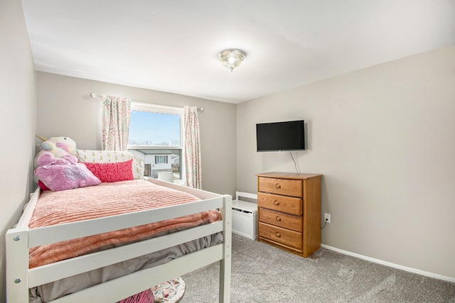 bedroom with light colored carpet and baseboards