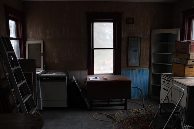 kitchen featuring wood walls and separate washer and dryer