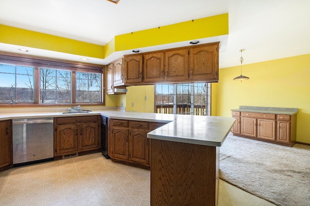 kitchen featuring plenty of natural light, a peninsula, a sink, and stainless steel dishwasher