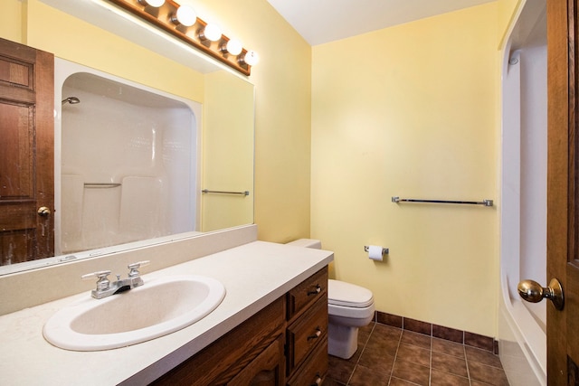 bathroom featuring toilet, tile patterned flooring, baseboards, walk in shower, and vanity