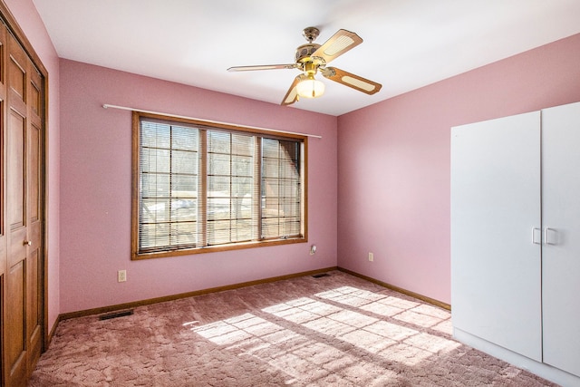 unfurnished bedroom featuring visible vents, baseboards, light carpet, and a closet