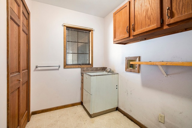 laundry area with baseboards, cabinet space, light floors, and hookup for a washing machine