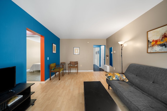 living area with light wood finished floors and baseboards