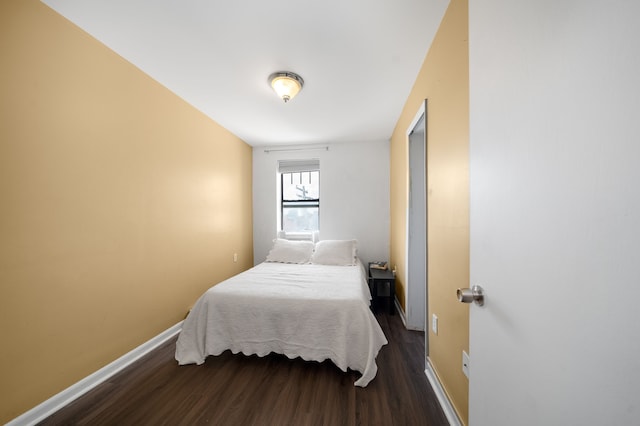 bedroom featuring dark wood-style floors and baseboards