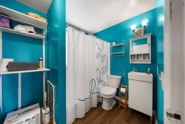 full bath with toilet, a shower with curtain, and wood finished floors