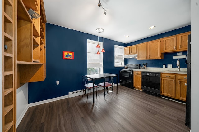 kitchen featuring dark wood-style floors, baseboard heating, light countertops, black appliances, and a sink