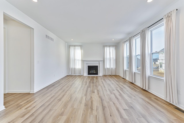 unfurnished living room with recessed lighting, visible vents, and light wood-style floors