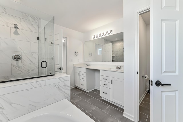 full bath with double vanity, a stall shower, a tub to relax in, and a sink