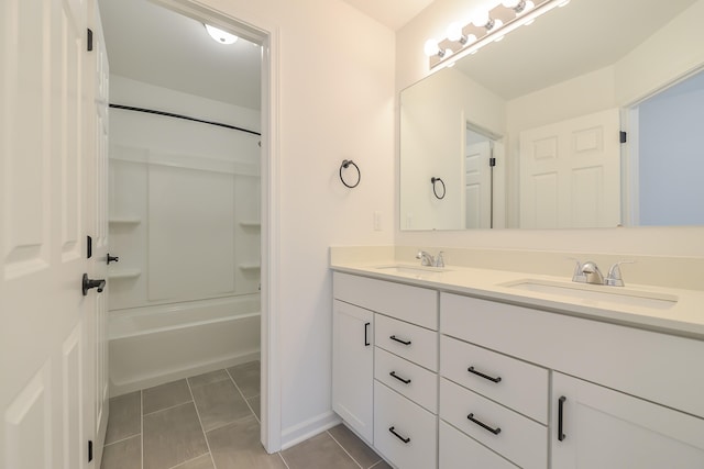 full bathroom with double vanity, bathtub / shower combination, a sink, and tile patterned floors