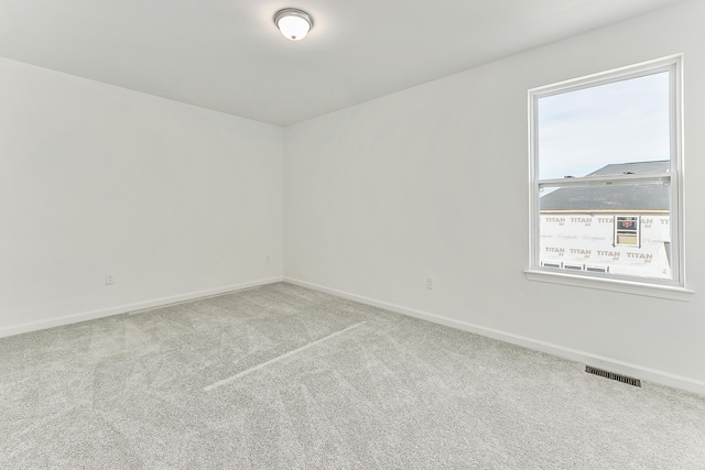 carpeted empty room with baseboards and visible vents