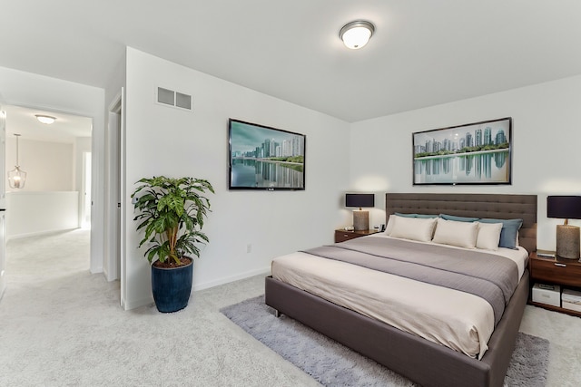 carpeted bedroom with visible vents and baseboards