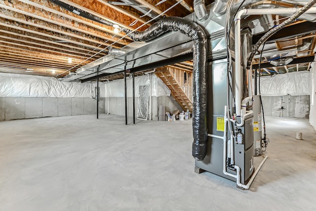 unfinished basement featuring gas water heater and heating unit