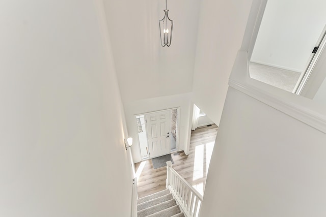 entrance foyer featuring stairs, a high ceiling, and light wood-type flooring