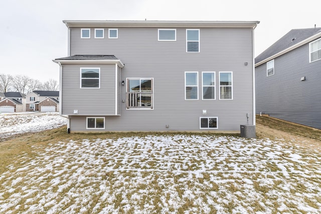 snow covered house featuring central air condition unit