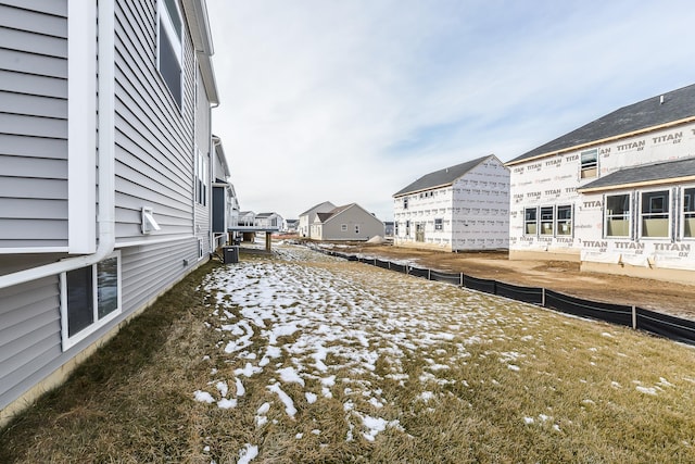 view of yard with central air condition unit, a residential view, and fence