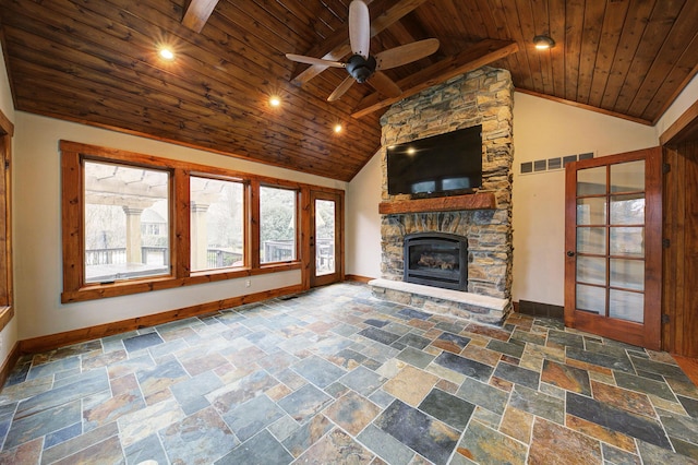 unfurnished living room with wood ceiling, visible vents, a wealth of natural light, and a stone fireplace