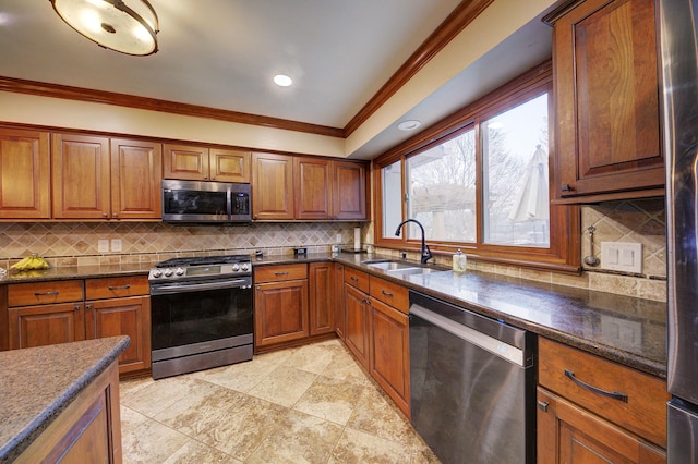 kitchen with appliances with stainless steel finishes, brown cabinets, and a sink