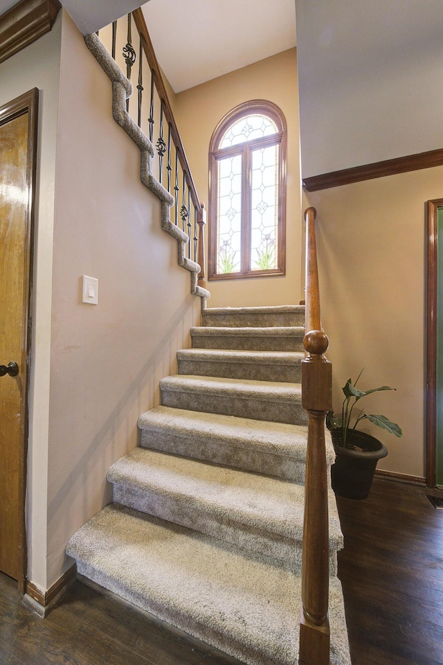 stairway with baseboards and wood finished floors