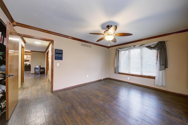 unfurnished room featuring crown molding, visible vents, dark wood-type flooring, ceiling fan, and baseboards