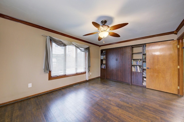 unfurnished bedroom with visible vents, crown molding, baseboards, and wood finished floors