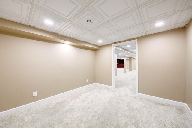 finished below grade area with light carpet, baseboards, and recessed lighting