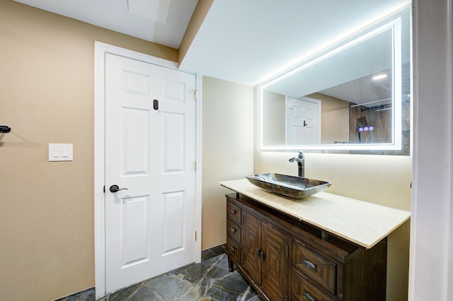 bathroom featuring marble finish floor, vanity, and baseboards