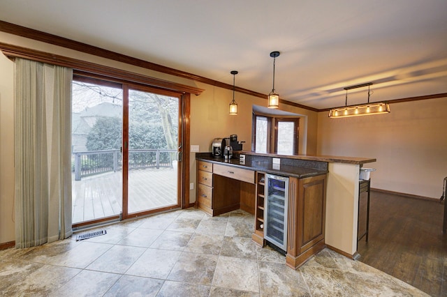 bar featuring ornamental molding, wine cooler, and plenty of natural light