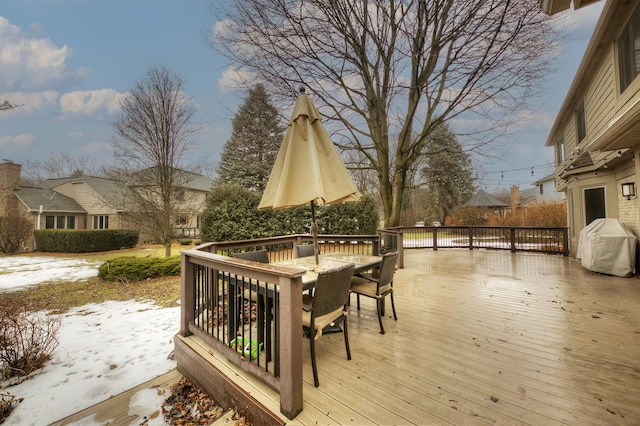 wooden deck featuring area for grilling and outdoor dining space