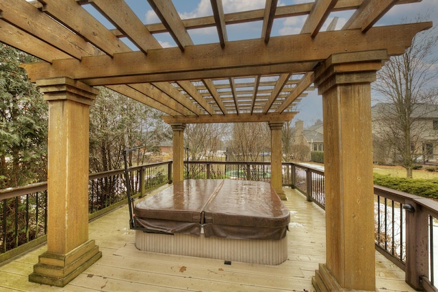 wooden deck featuring a covered hot tub and a pergola