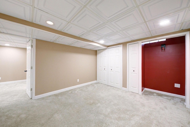 finished below grade area with recessed lighting, baseboards, and light colored carpet