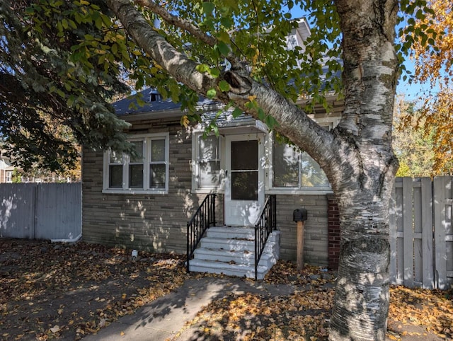 view of front of house featuring entry steps and fence