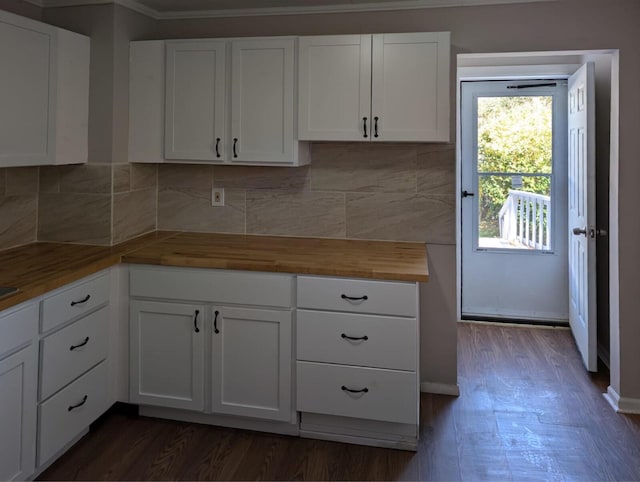 kitchen with wooden counters, tasteful backsplash, dark wood-style flooring, and white cabinetry