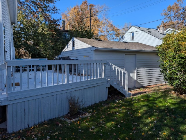 rear view of house with a deck and a lawn