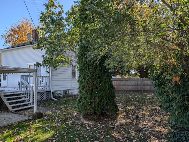 view of yard featuring fence and a wooden deck