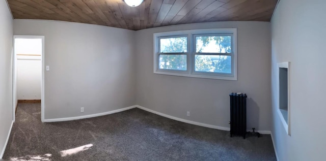 carpeted empty room with lofted ceiling, wooden ceiling, radiator heating unit, and baseboards