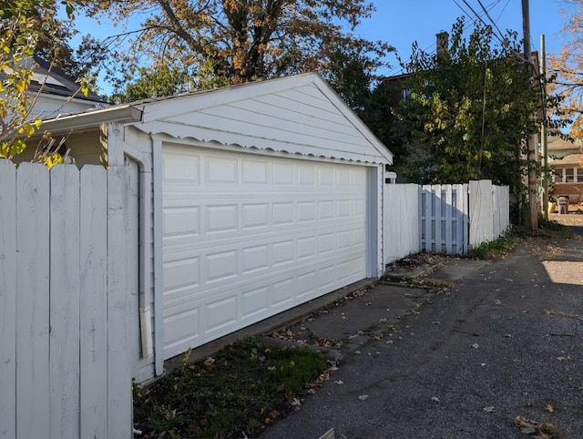 detached garage featuring fence