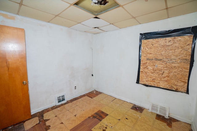 laundry area with baseboards, visible vents, and light floors