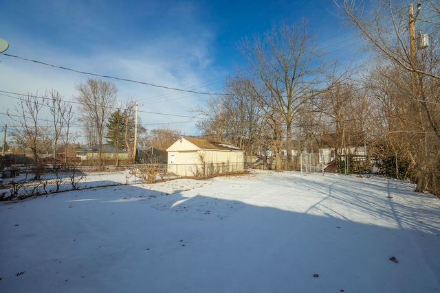 yard covered in snow featuring fence