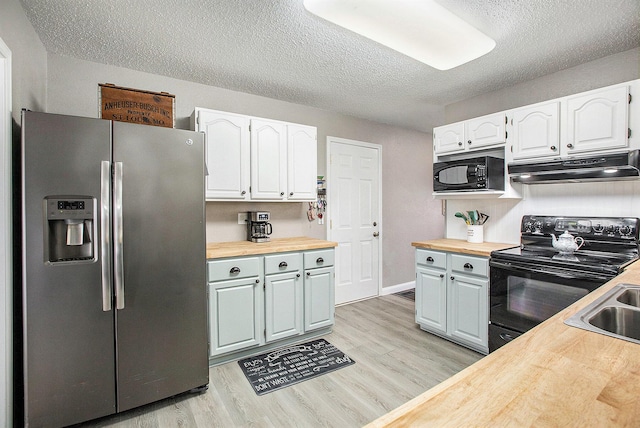 kitchen featuring black appliances, butcher block counters, under cabinet range hood, and white cabinets