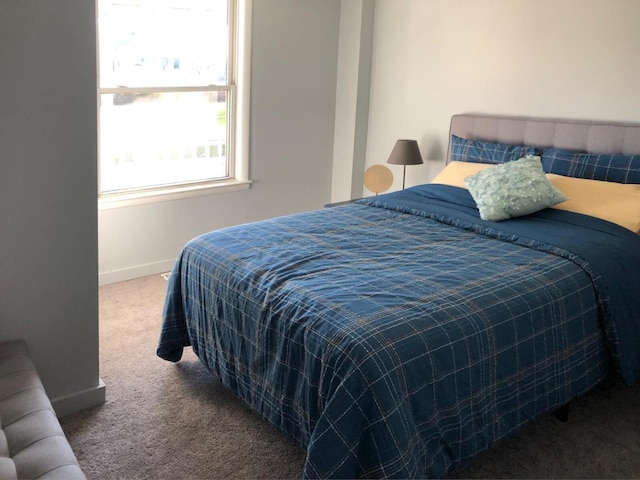 bedroom with carpet and baseboards